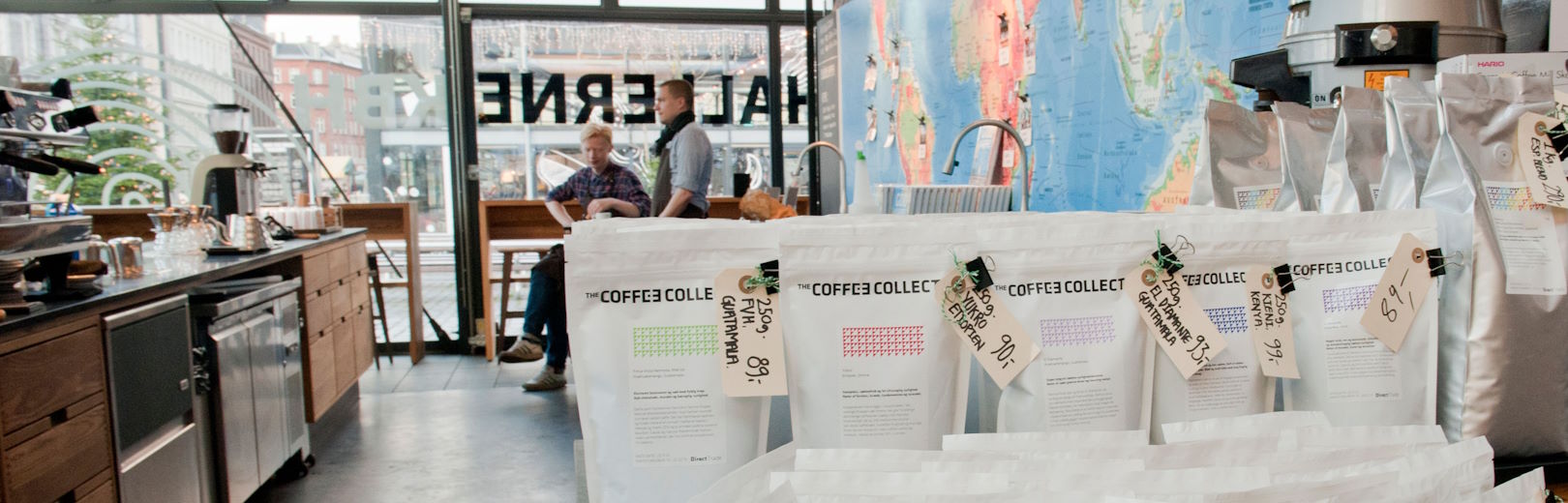 Coffee Collective roasted coffee bags at a café.