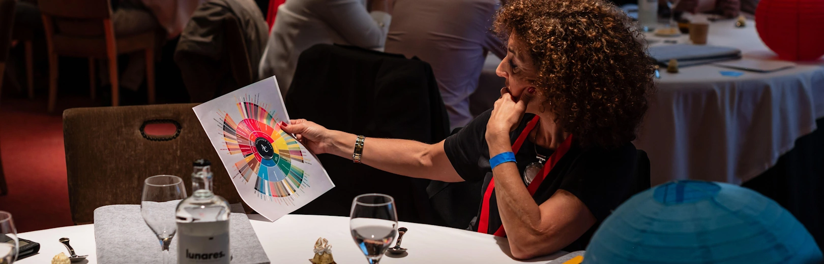 A woman looks at the Coffee Taster's Flavor Wheel at an event.