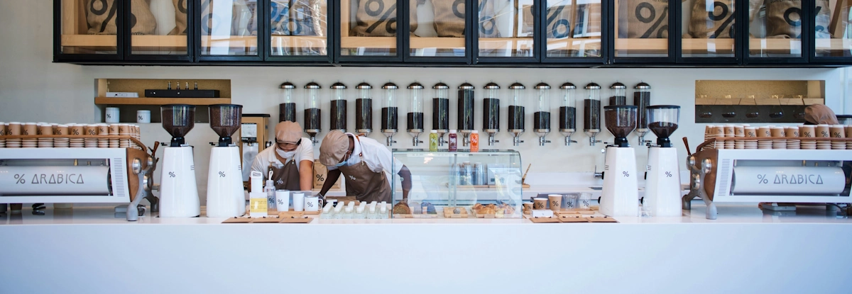 Two baristas in a % Arabica coffee shop.