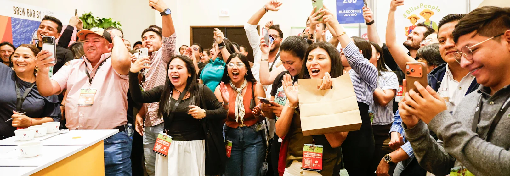A crowd of people celebrate the winner of the Global Cupping Championship at PRF El Salvador.