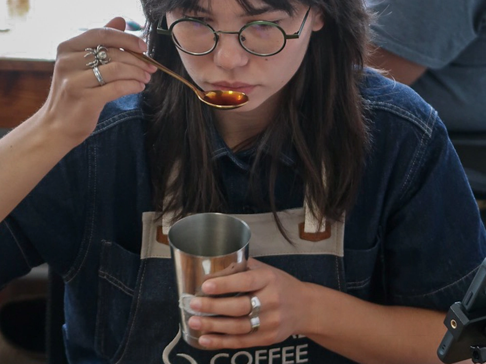 Alsu Karimova cups coffee at the Global Coffee Awards Asia.