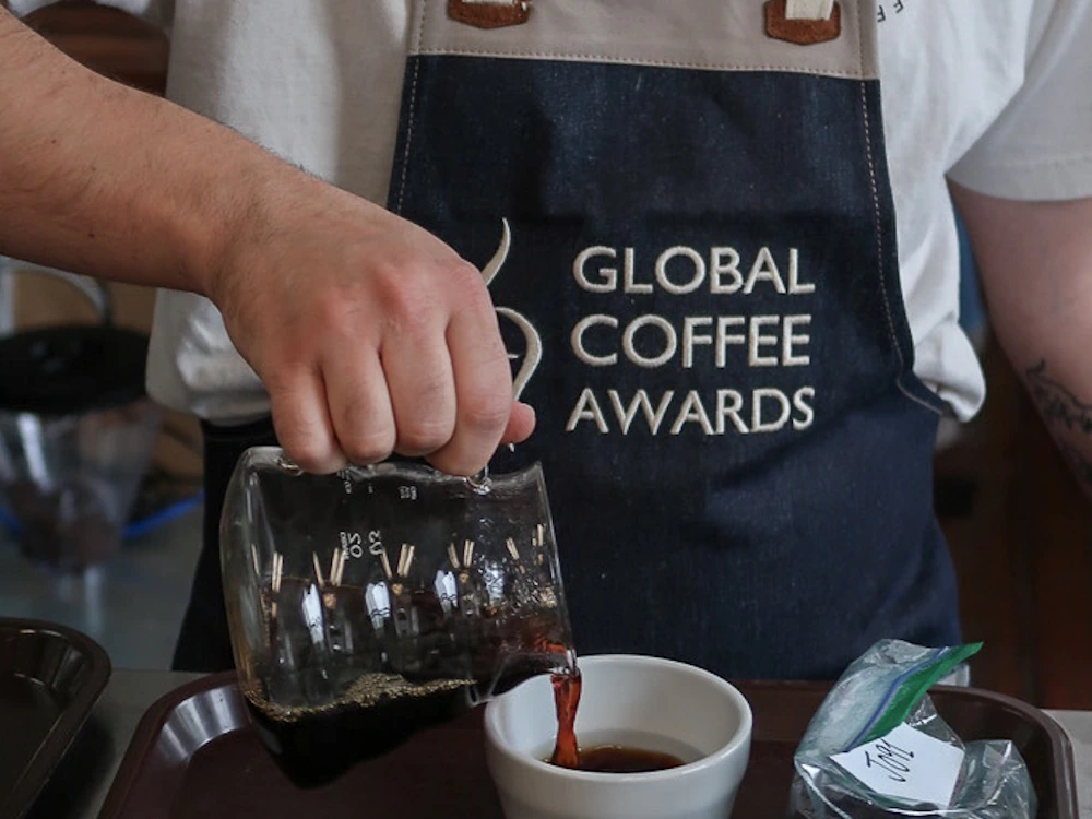 A barista prepares a coffee sample at the Global Coffee Awards Africa.