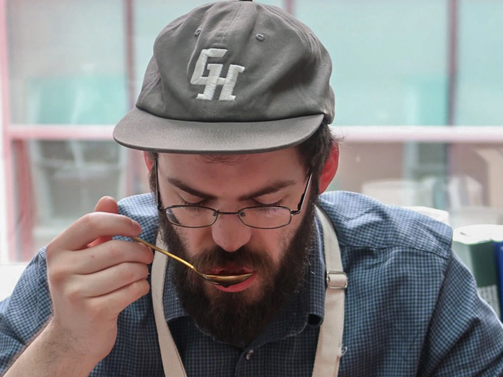 A judge cups coffee at the Global Coffee Awards Asia.