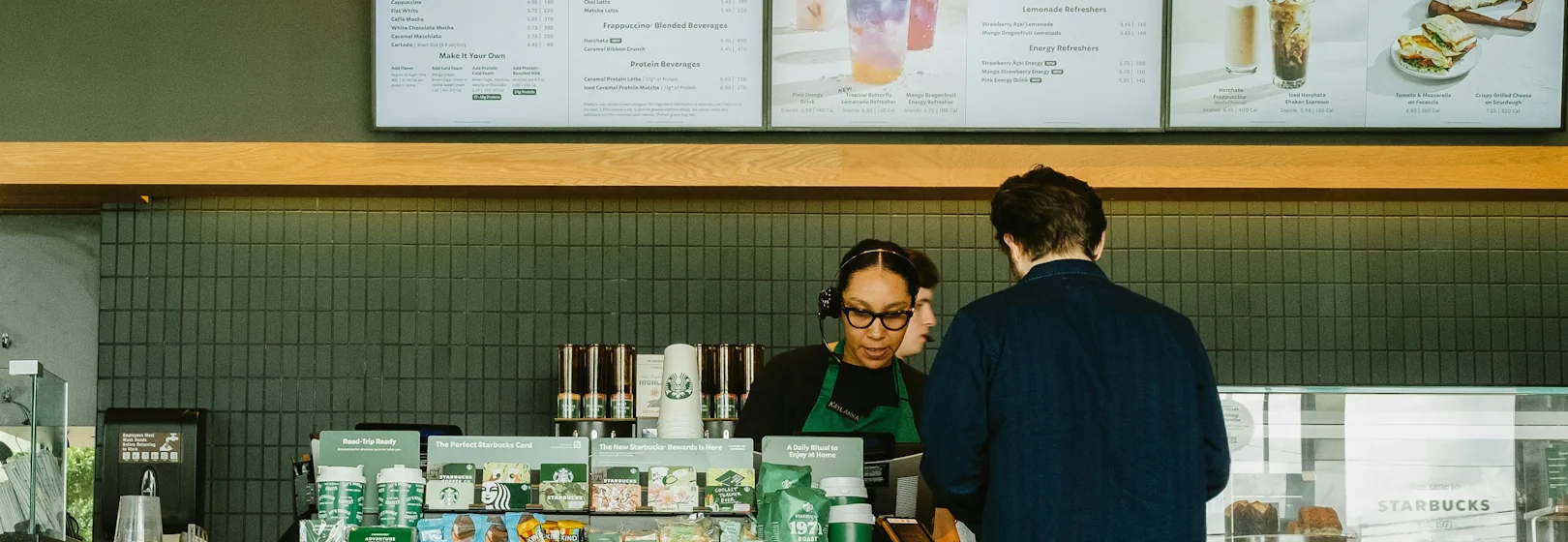 A barista serves a customer at Starbucks.