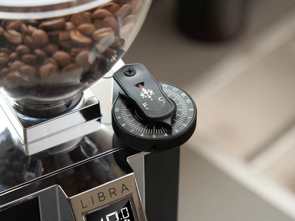 A slow feeding mechanism on a Eureka grinder.